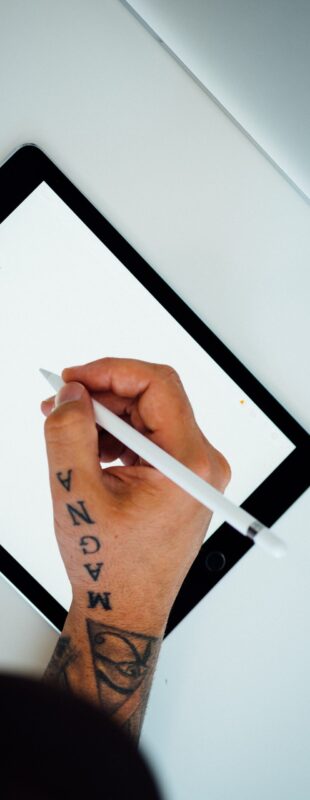 how to become a tattoo artist. tattoo artist. The hand of a man sketching on a tablet.
