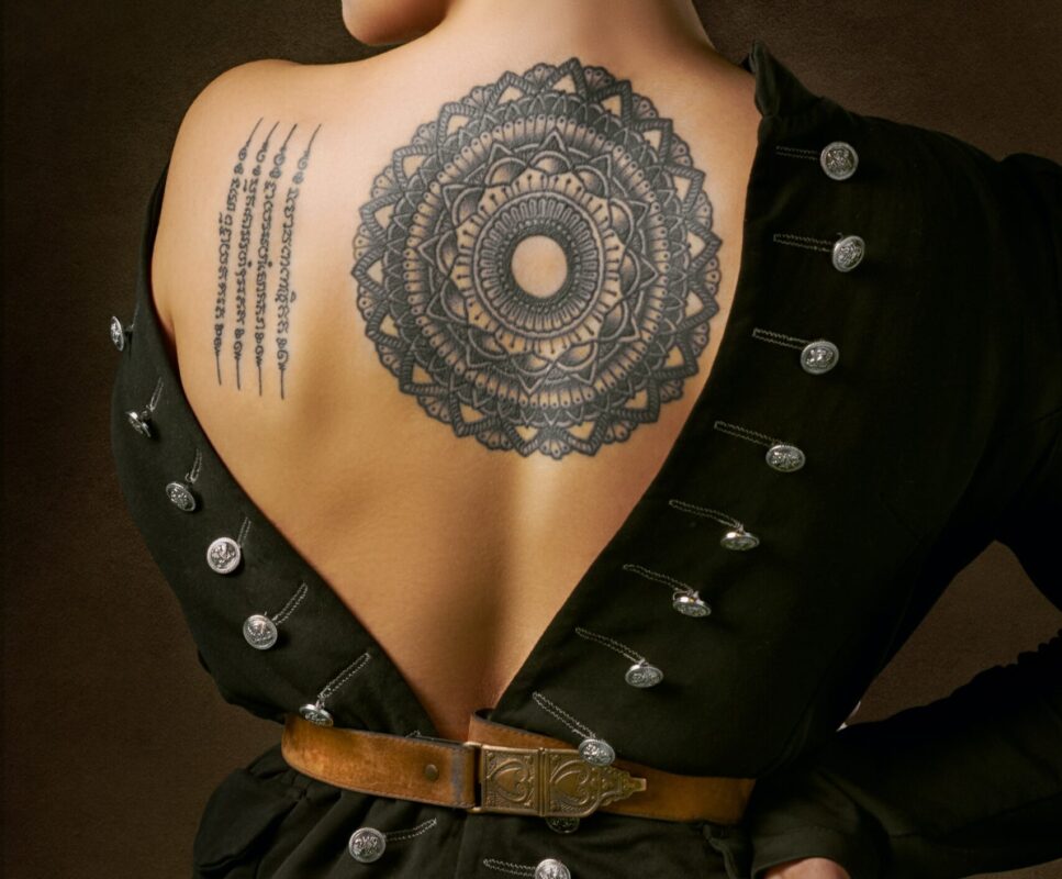 How to become a tattoo artist. tattoo artist. The back of a woman with an oriental tattoo.